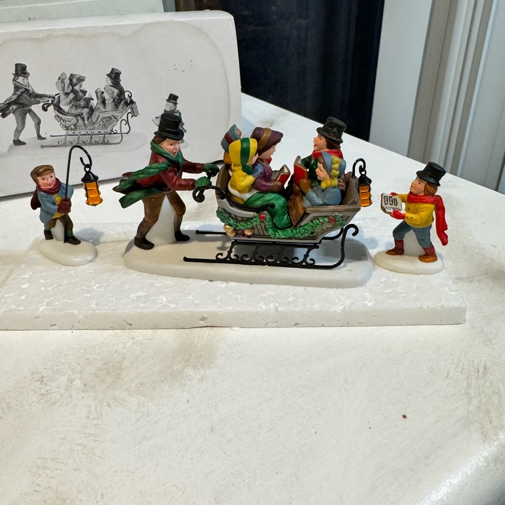 Dept 56 caroling with the cratch family